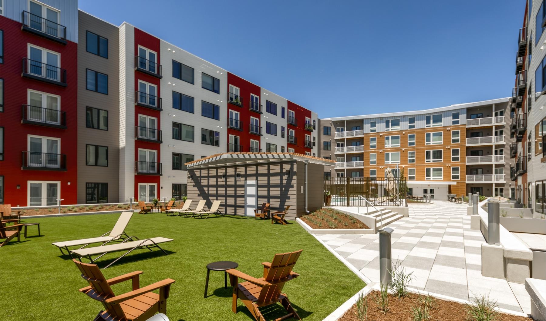 The essence of exceptional living a courtyard with chairs and tables and buildings in the background