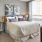 a bedroom with a bed desk and a window