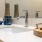 a sink with a soap dispenser and a soap dispenser